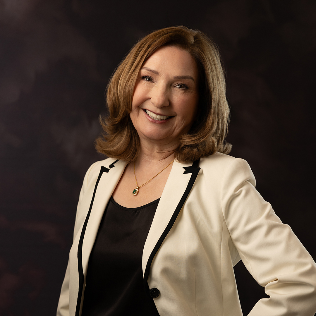 Portrait of author Ann Landers, LMFT, smiling warmly in a cream blazer